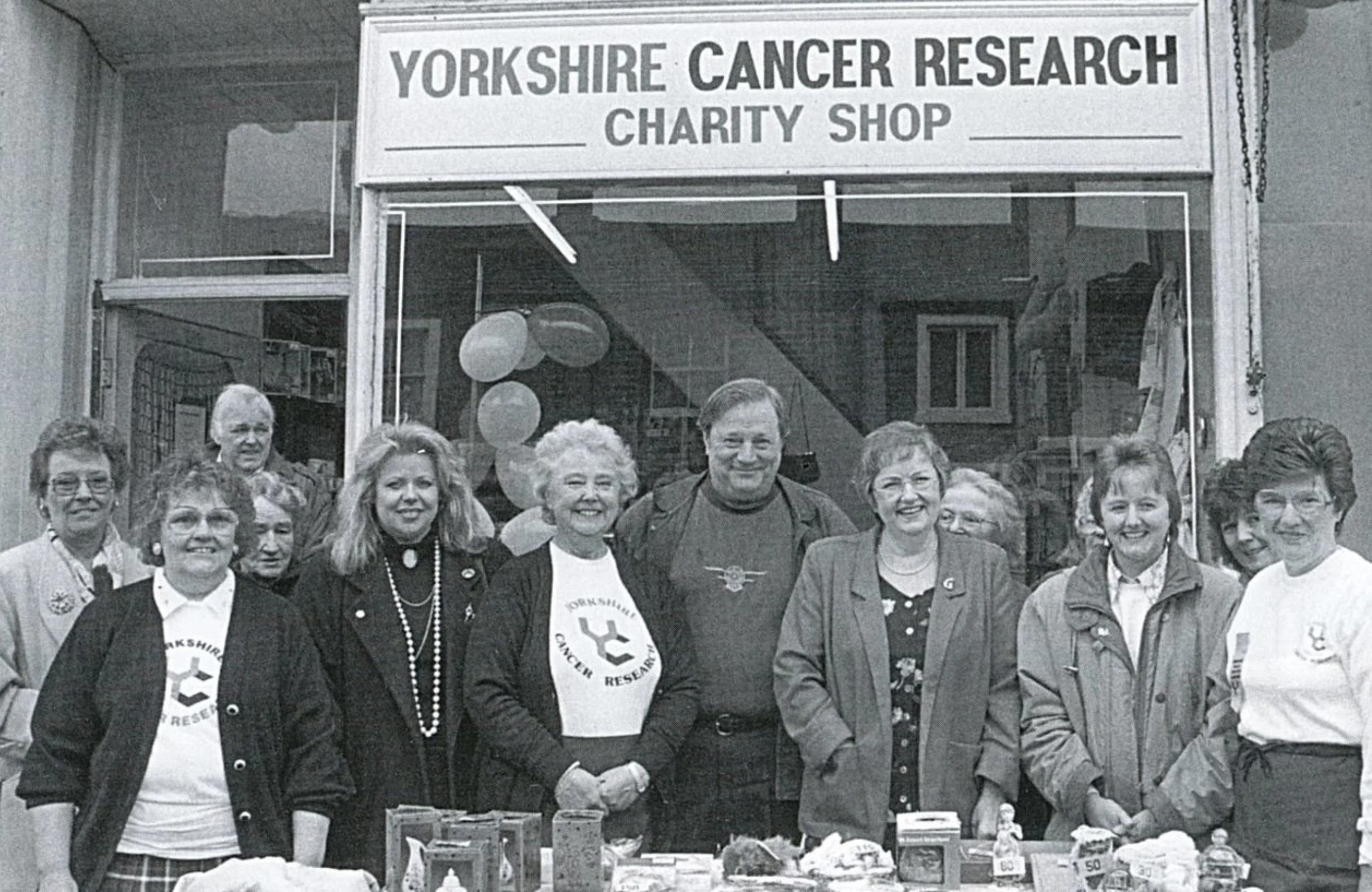 The Halifax Local Volunteer Group gather in front of the opening of the first Halifax shop