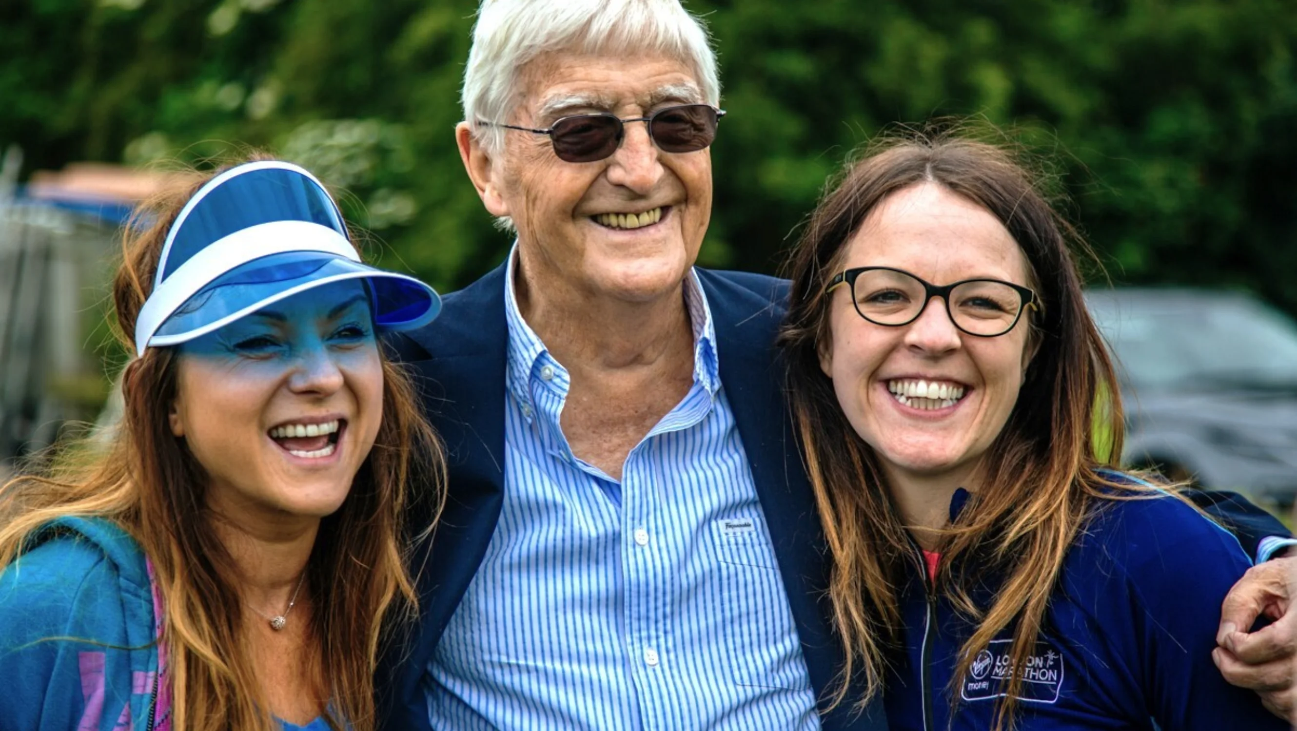 Two supporters pose with Sir Michael Parkinson
