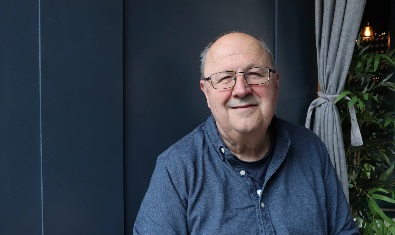 Gary Lovelace sitting and smiling at the camera