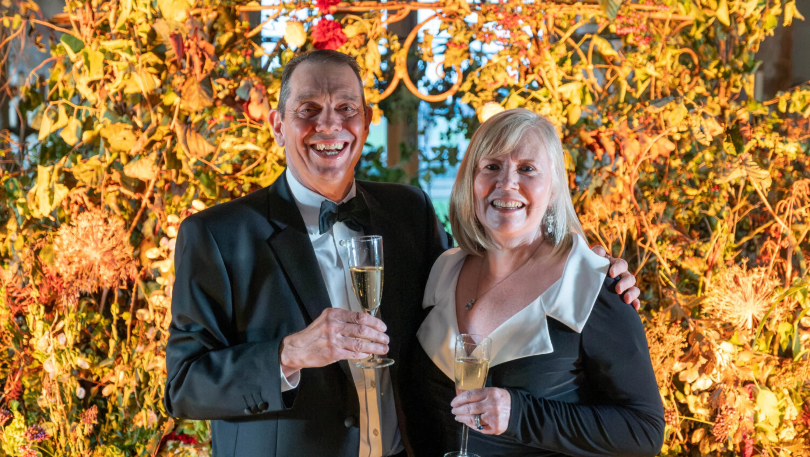 Guests standing in front of the autumnal decoration