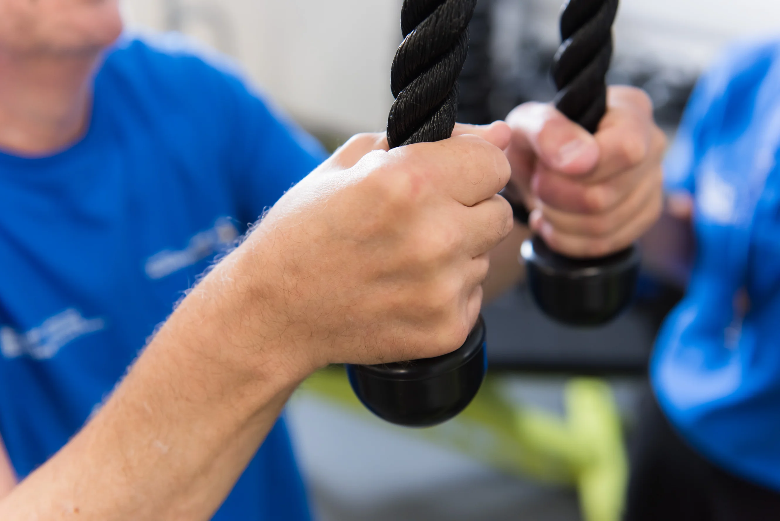 Two hands pulling on a fitness tool
