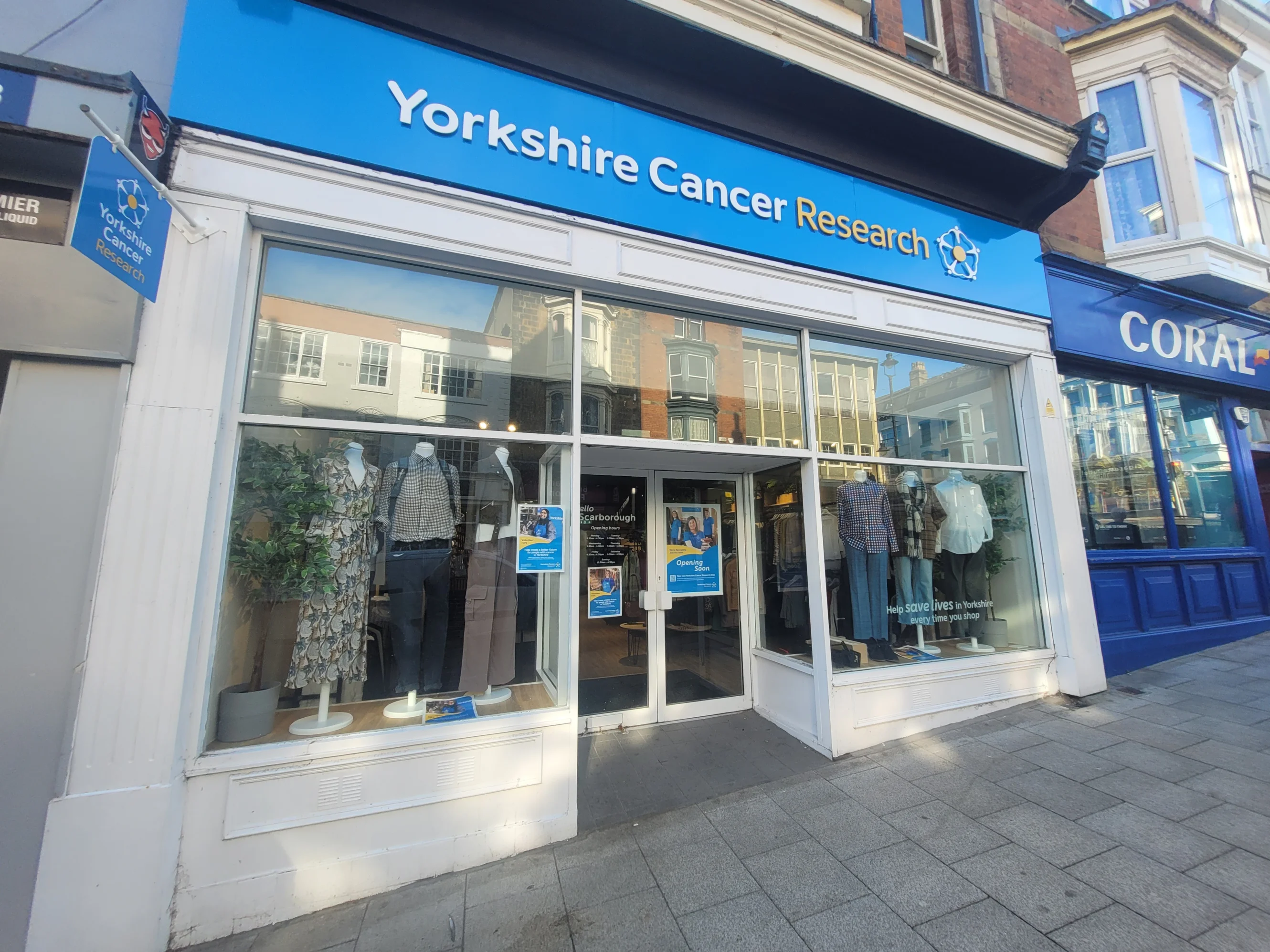 The Scarborough shop front. Above is the charity's logo on a blue background.
