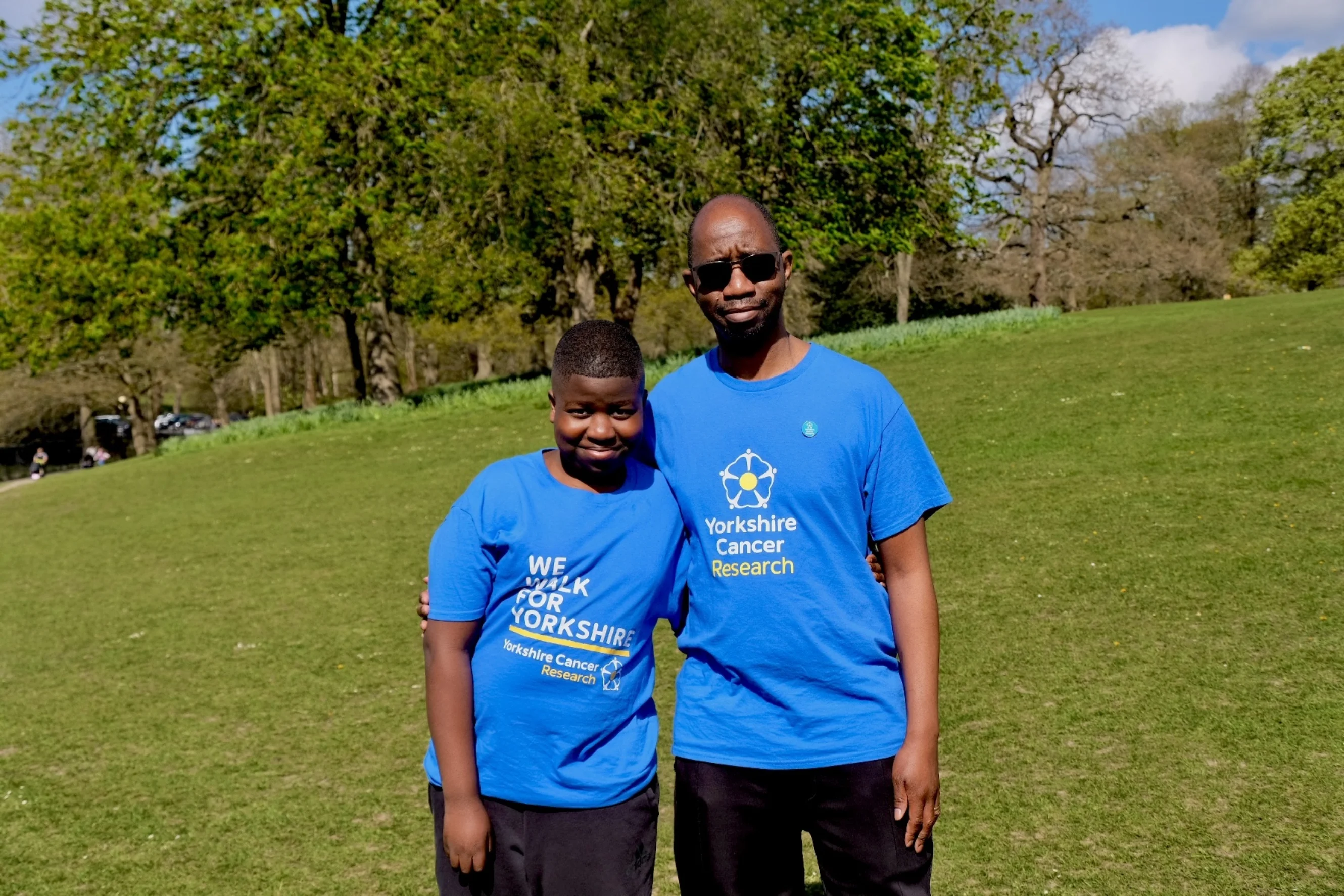 Vallentyne and his son Christian are wearing blue "We Walk for Yorkshire" T-shirts. They are both outside and smiling at the camera.