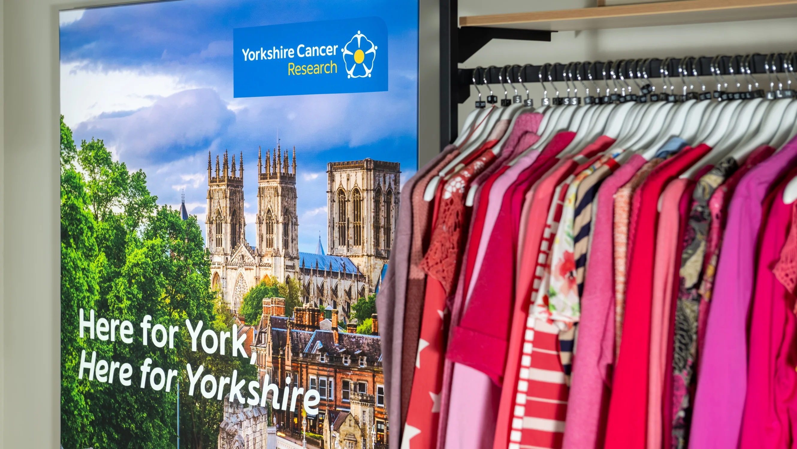 A lightbox sign with a photo of York Minster on it. Over the image is text that reads "here for York, here for Yorkshire"