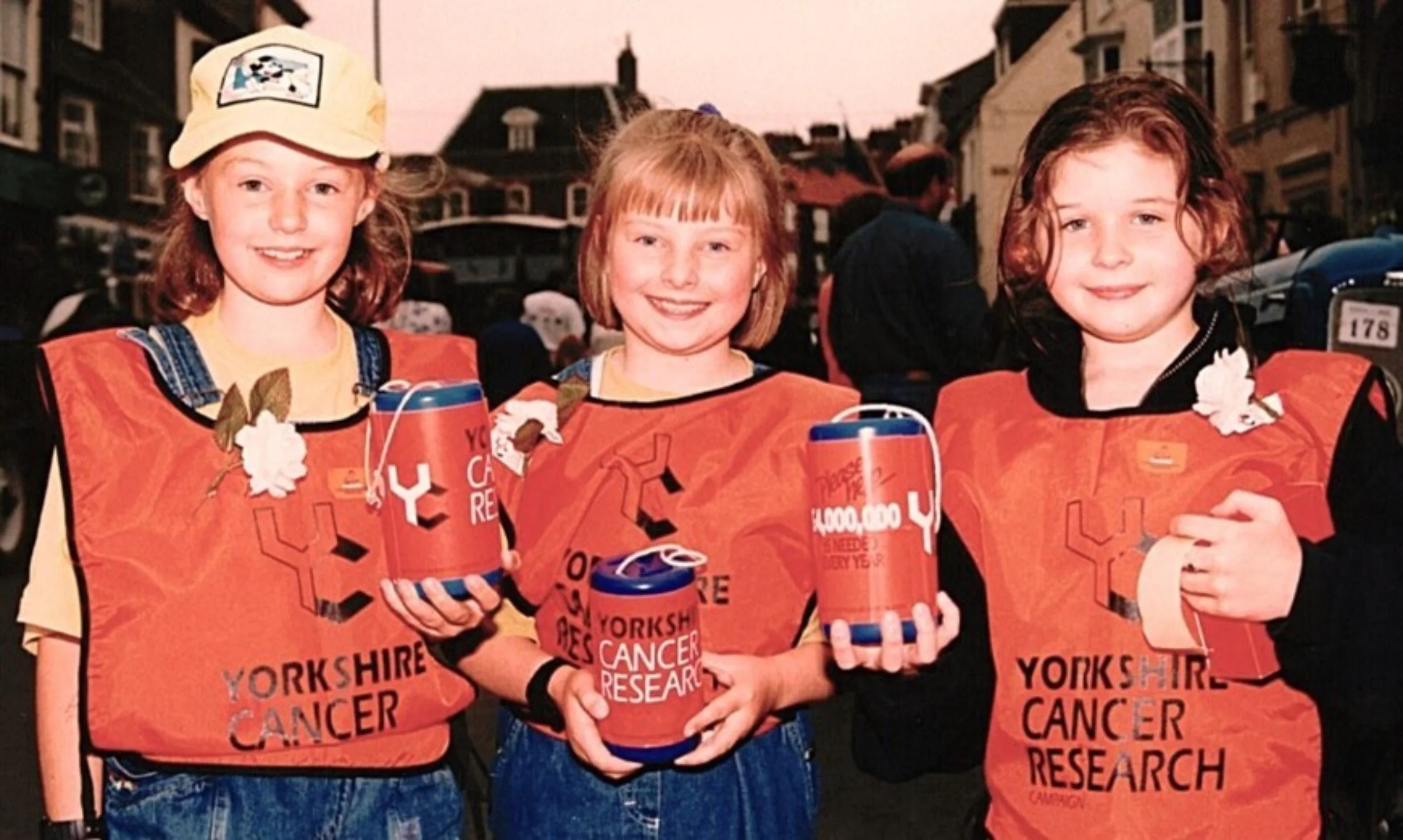 In 1998, three young girls were helping out at the annual Driffield Steam Rally, dressed in orange Yorkshire Cancer Research vests and holding collection tins.