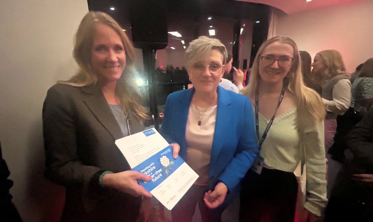 Hannah Pilling, Policy and Public Affairs Manager at Yorkshire Cancer Research, and Rowan Ellis Hollins, Public Affairs Officer at Yorkshire Cancer Research, present the White Rose campaign letter to Health Minister Ashley Dalton at the Labour Party Conference.