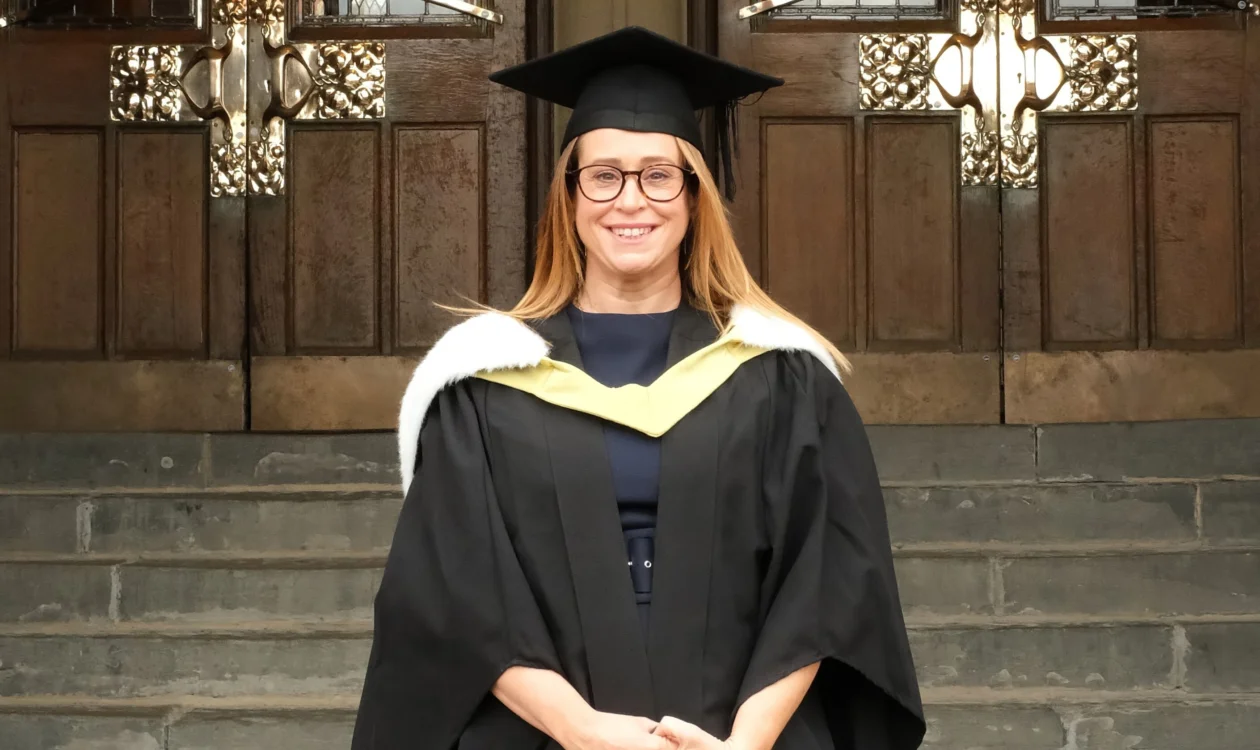 Emily wearing a graduation gown and cap