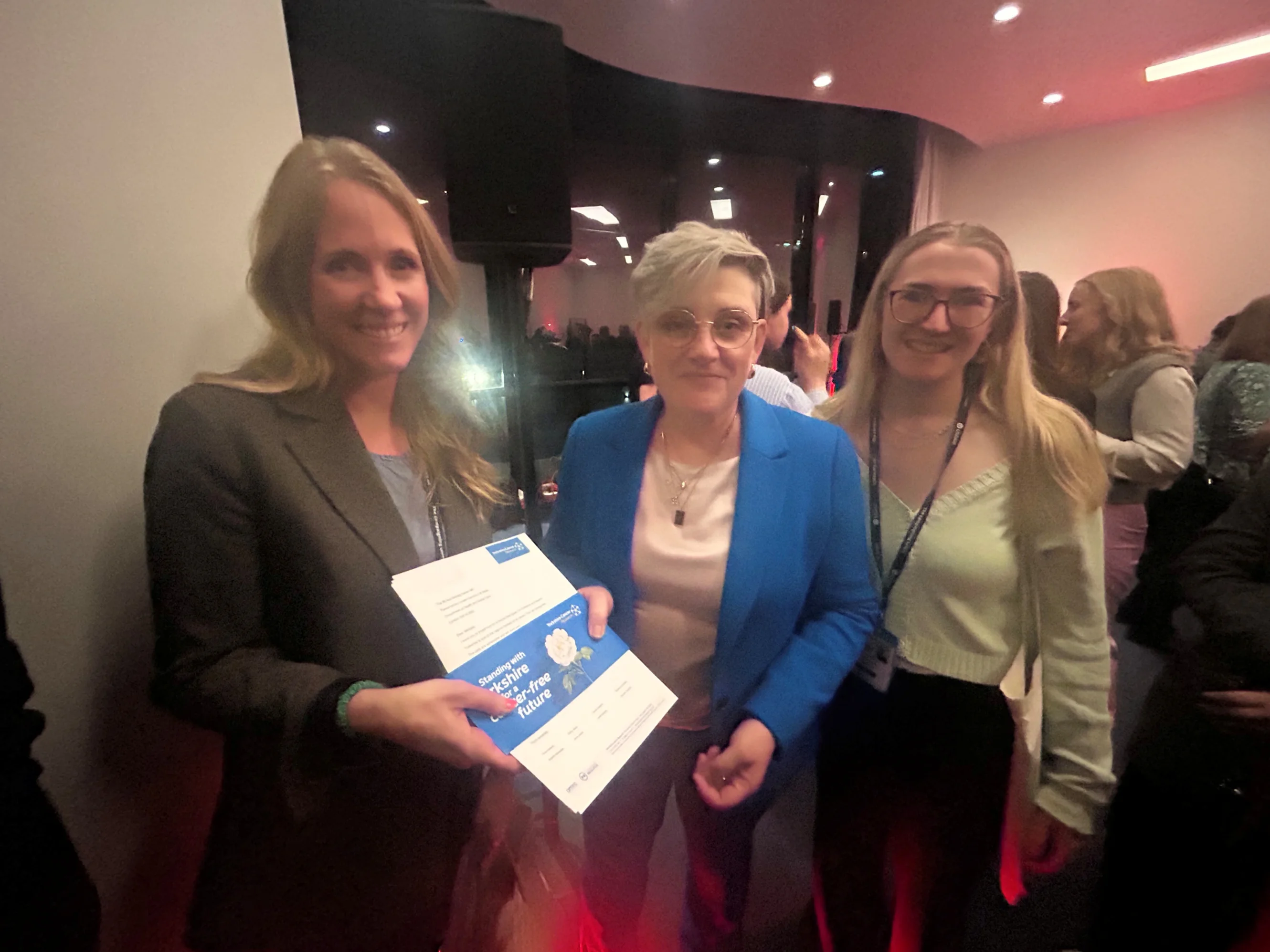 Hannah Pilling, Policy and Public Affairs Manager at Yorkshire Cancer Research, and Rowan Ellis Hollins, Public Affairs Officer at Yorkshire Cancer Research, present the White Rose campaign letter to Health Minister Ashley Dalton at the Labour Party Conference.