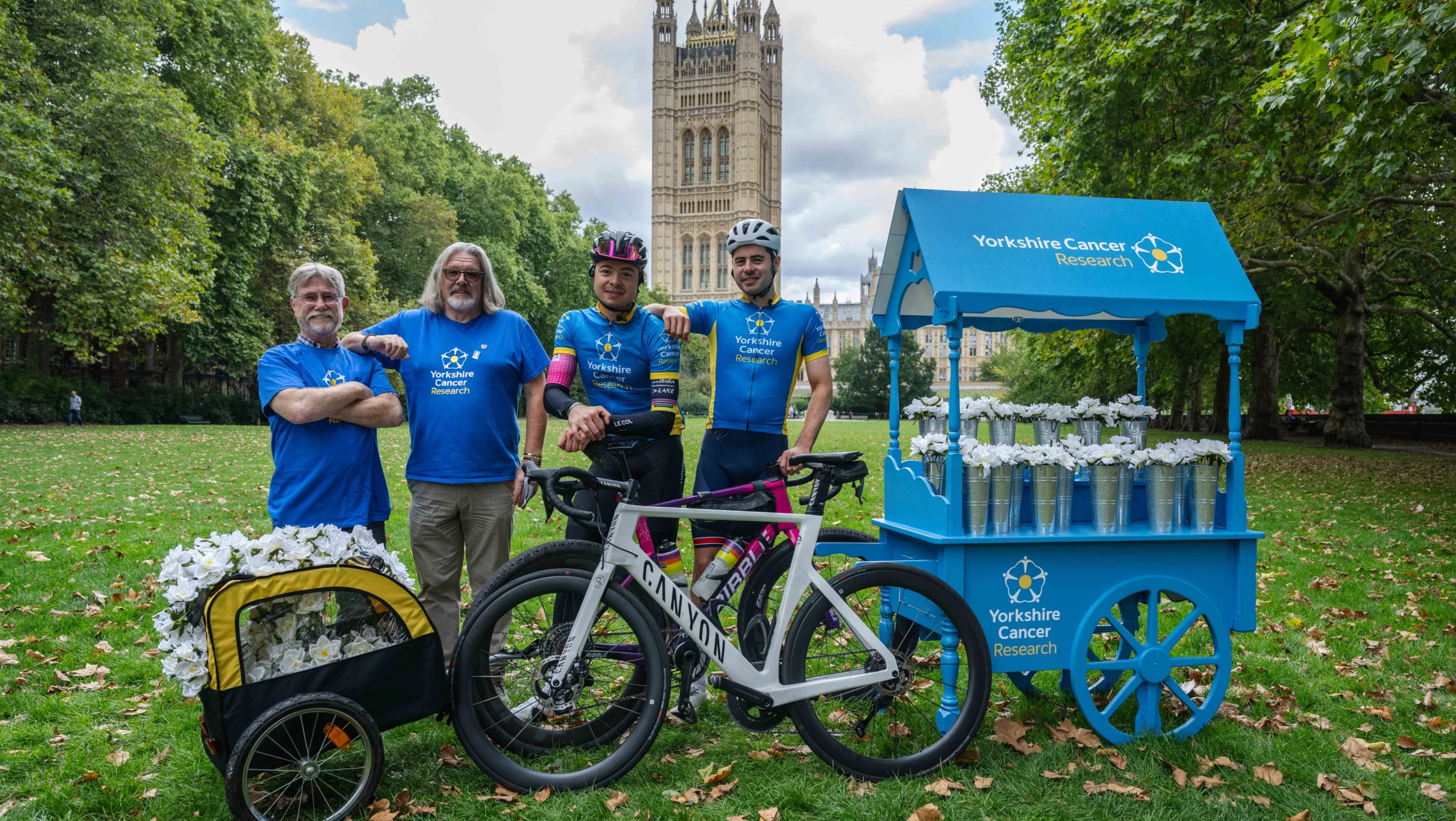 Campaign supporters Geoff Rodley and Neil Garner greet the Tanfield brothers as they deliver 500 paper roses to Westminster
