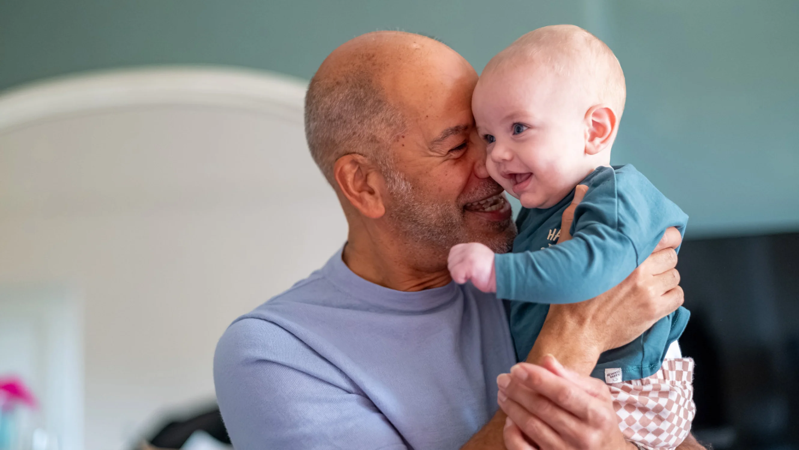 Russell holding up his grandson Edison