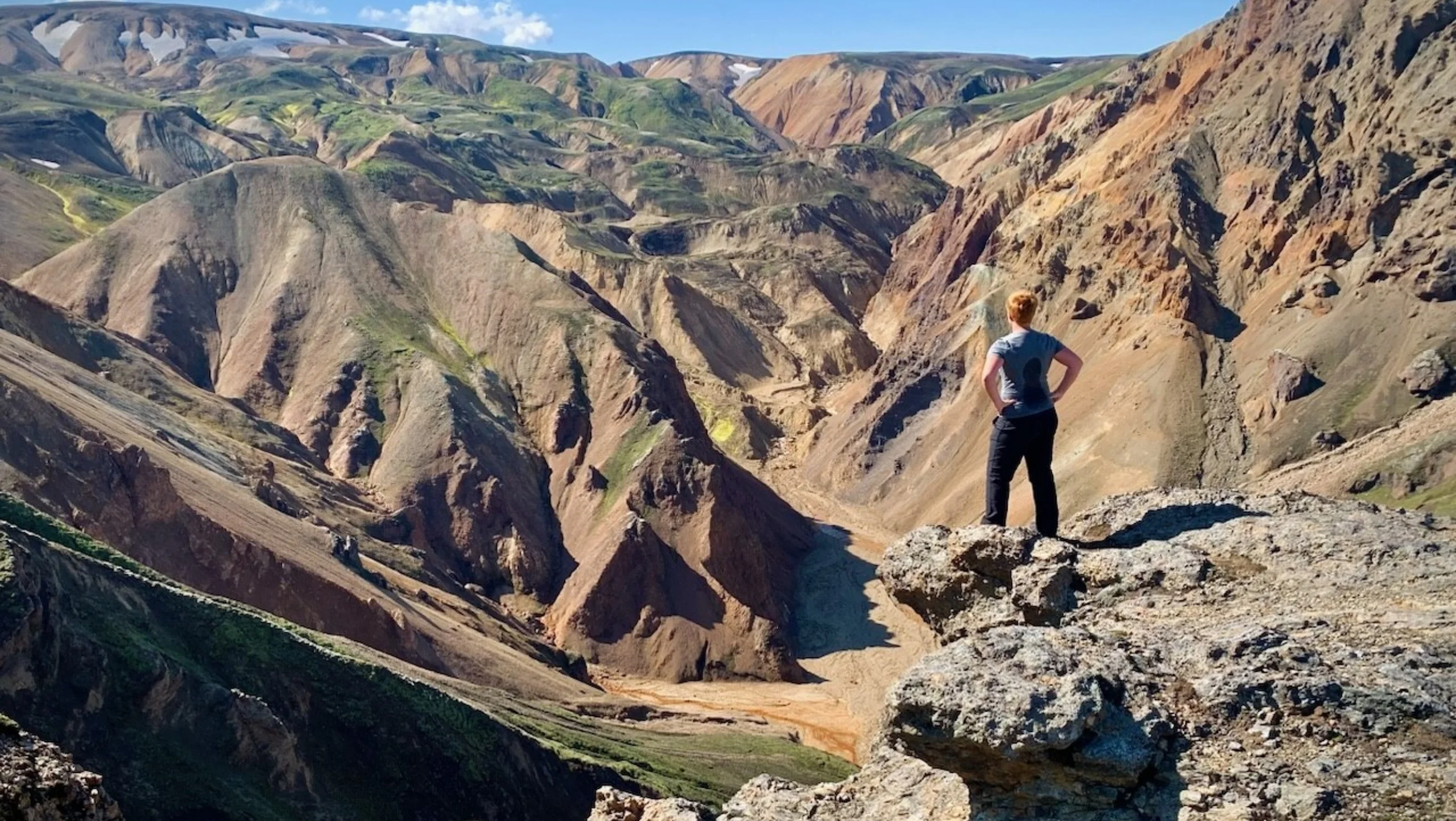 Woman standing amongst mountains.