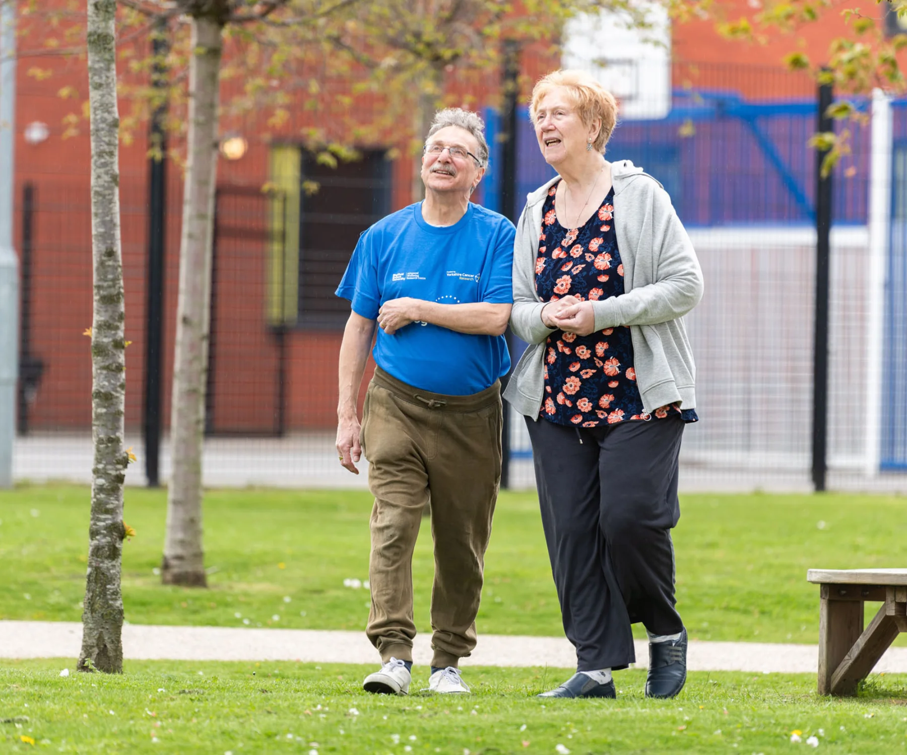 Male and female Active Together participants walking through a green space