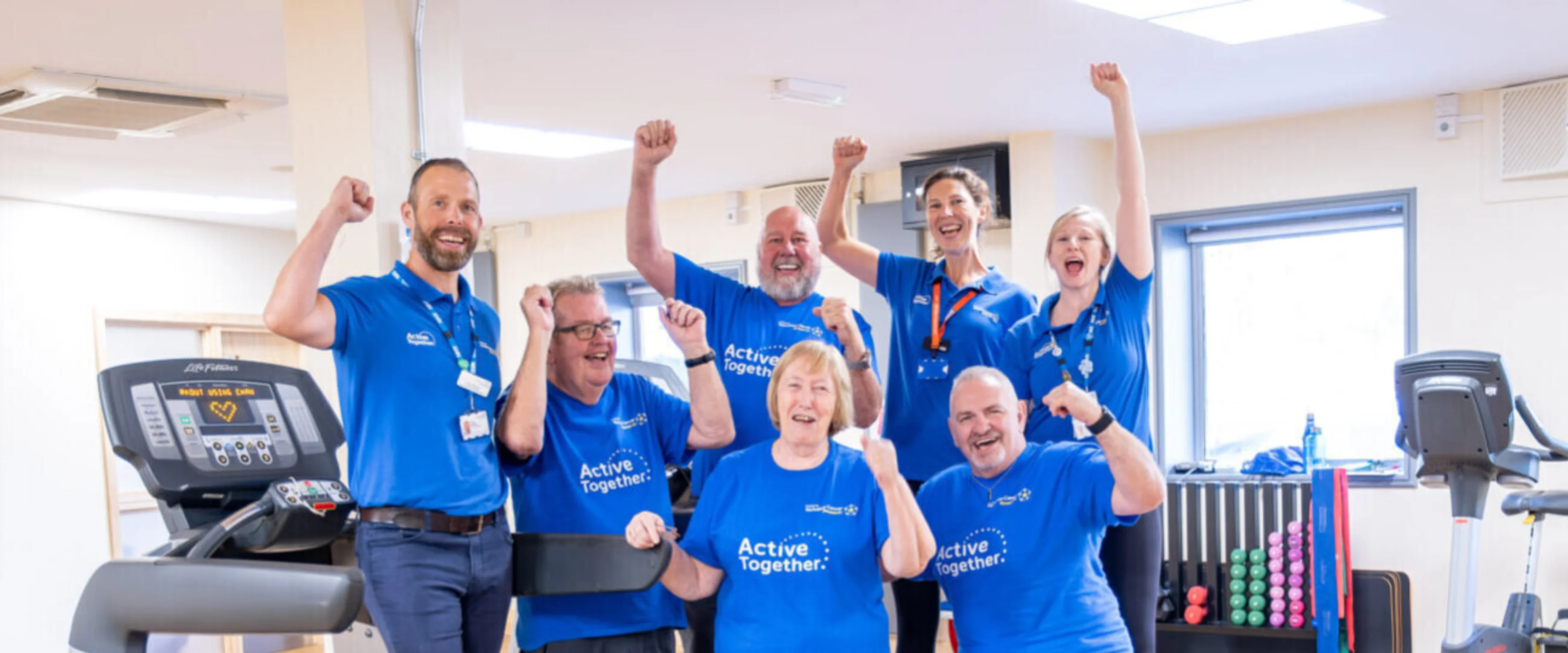 A group of people in a gym cheering