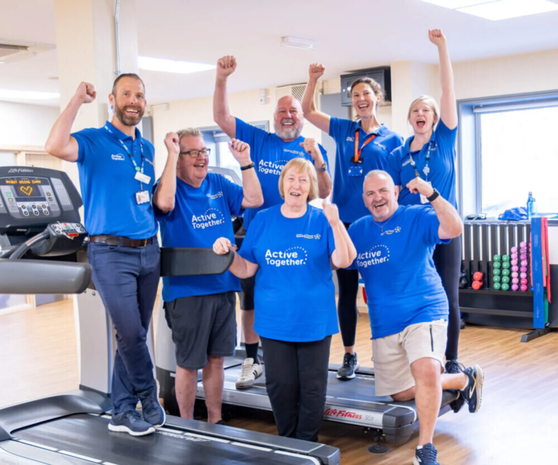 A group of people in a gym cheering