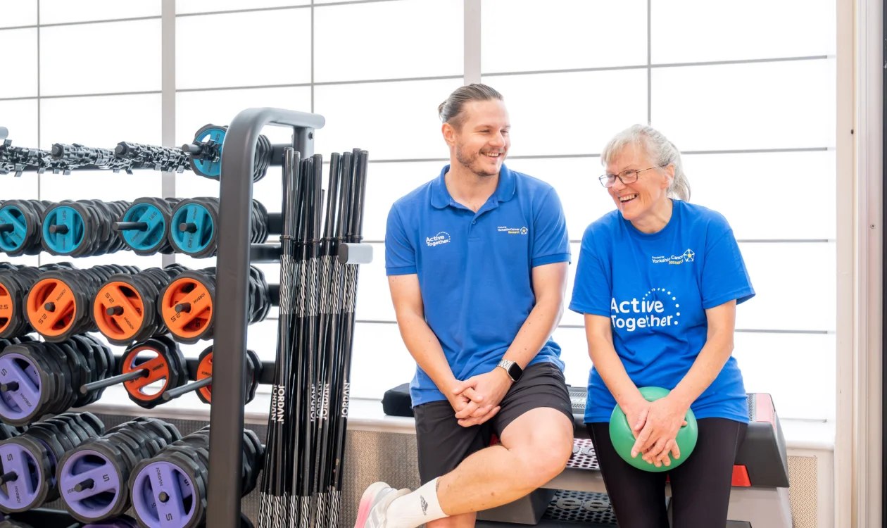 Two people wearing blue in a gym studio