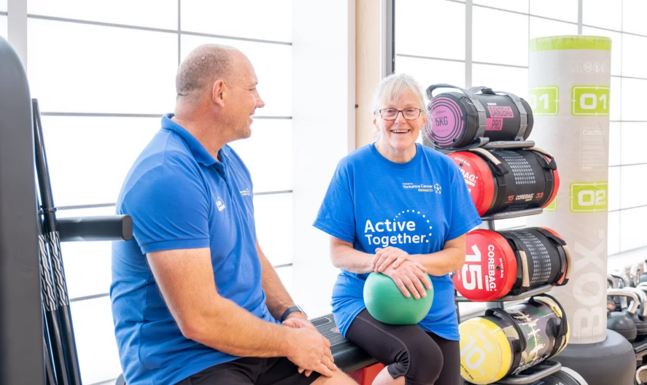 Two people in a gym dressed in blue