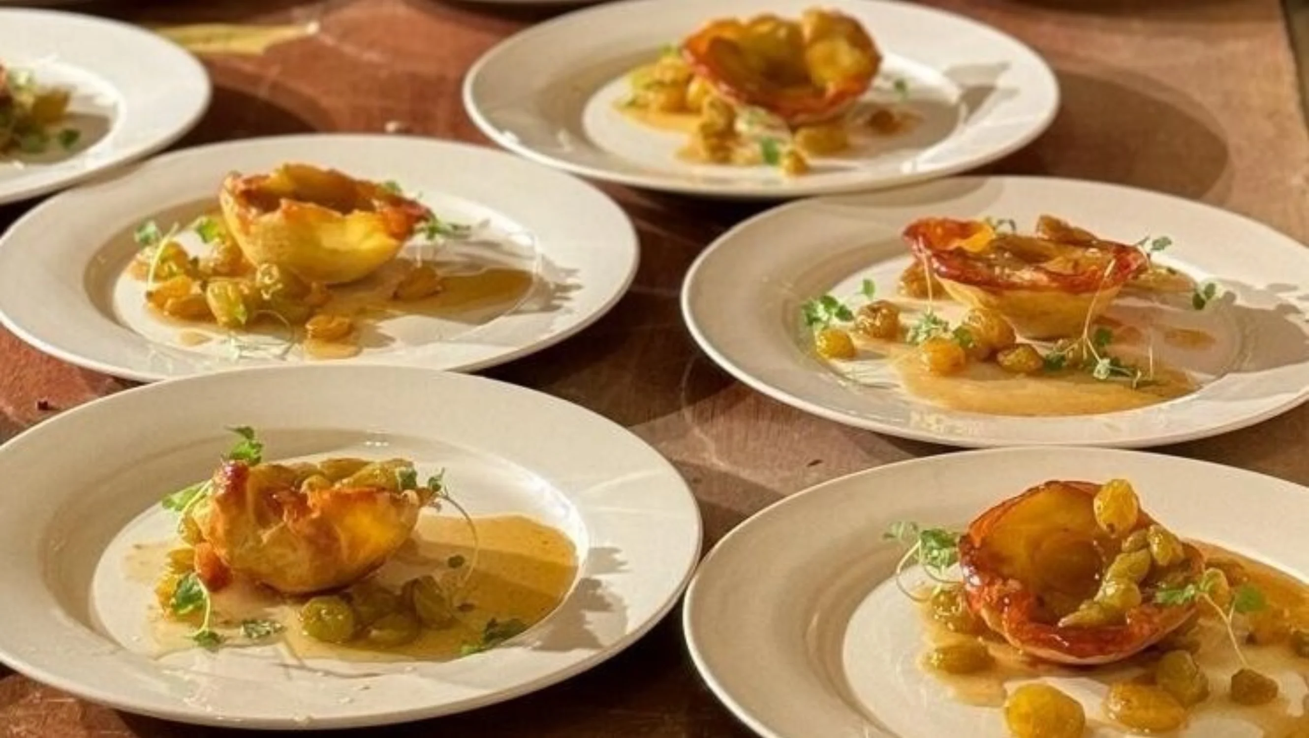 Several plates laid out by a chef ready for service