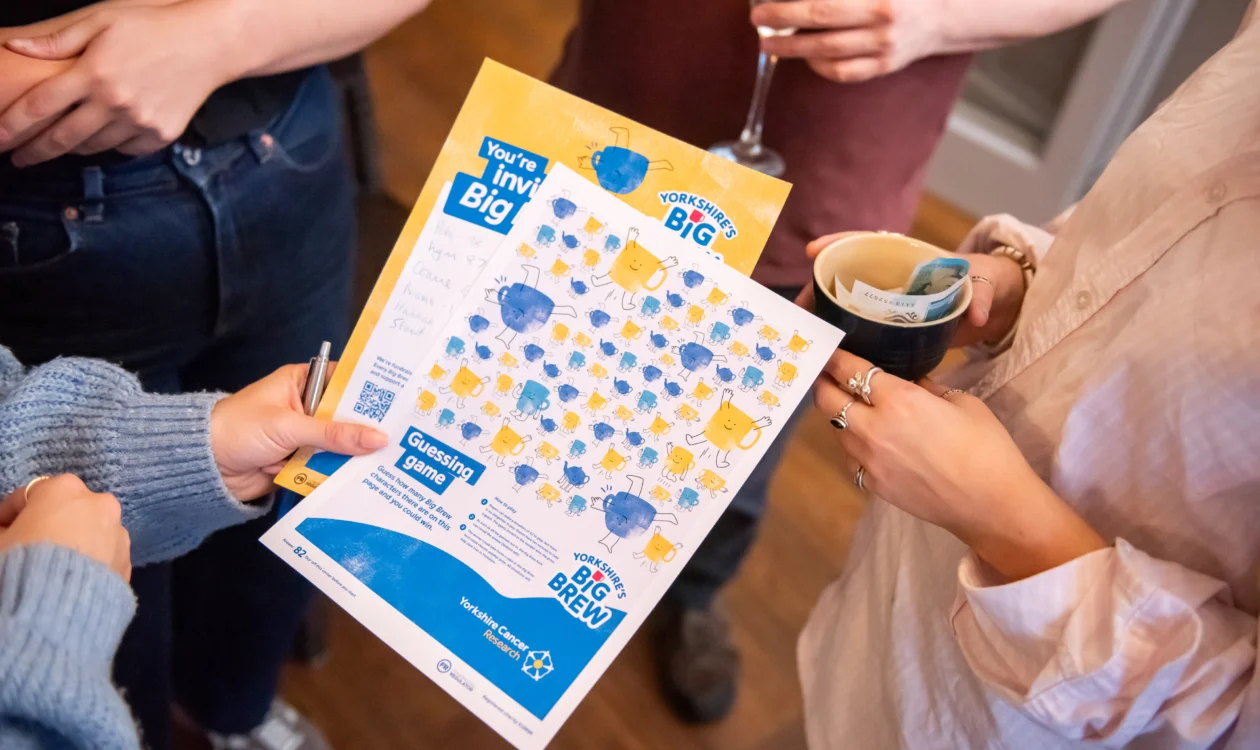 hands holding some Big Brew print outs