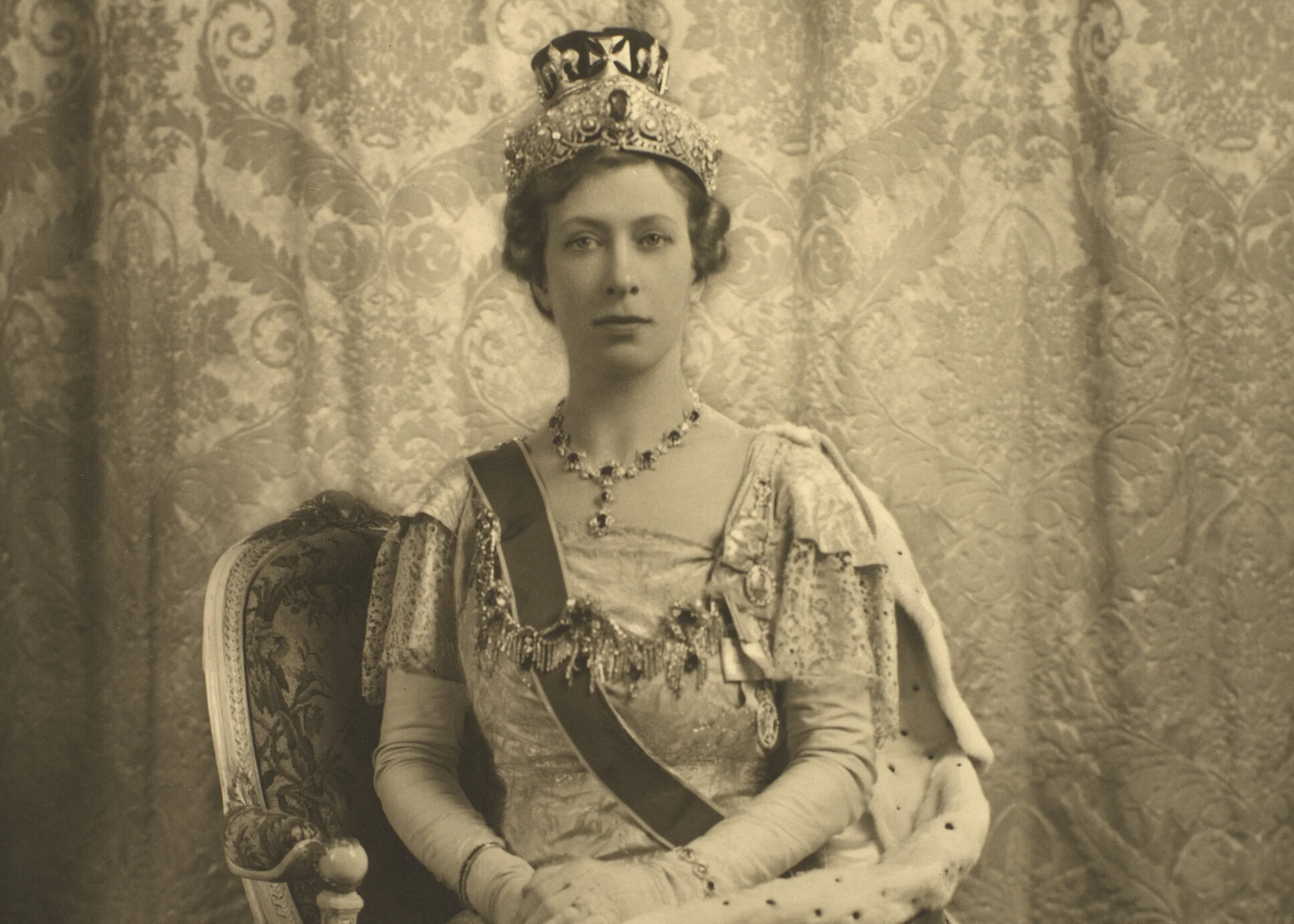 Princess Mary in a vintage photograph. She is wearing a crown and is adorned with jewels.