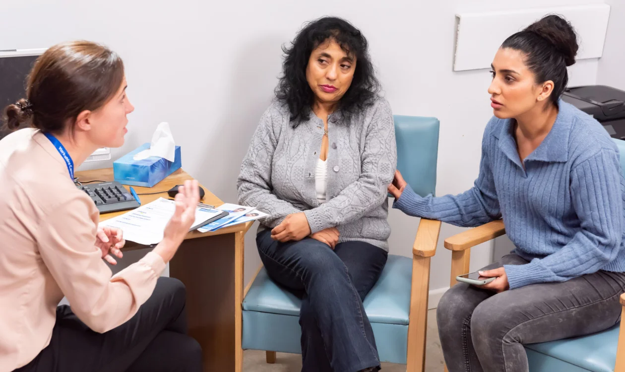 Parent and daughter in conversation with a GP