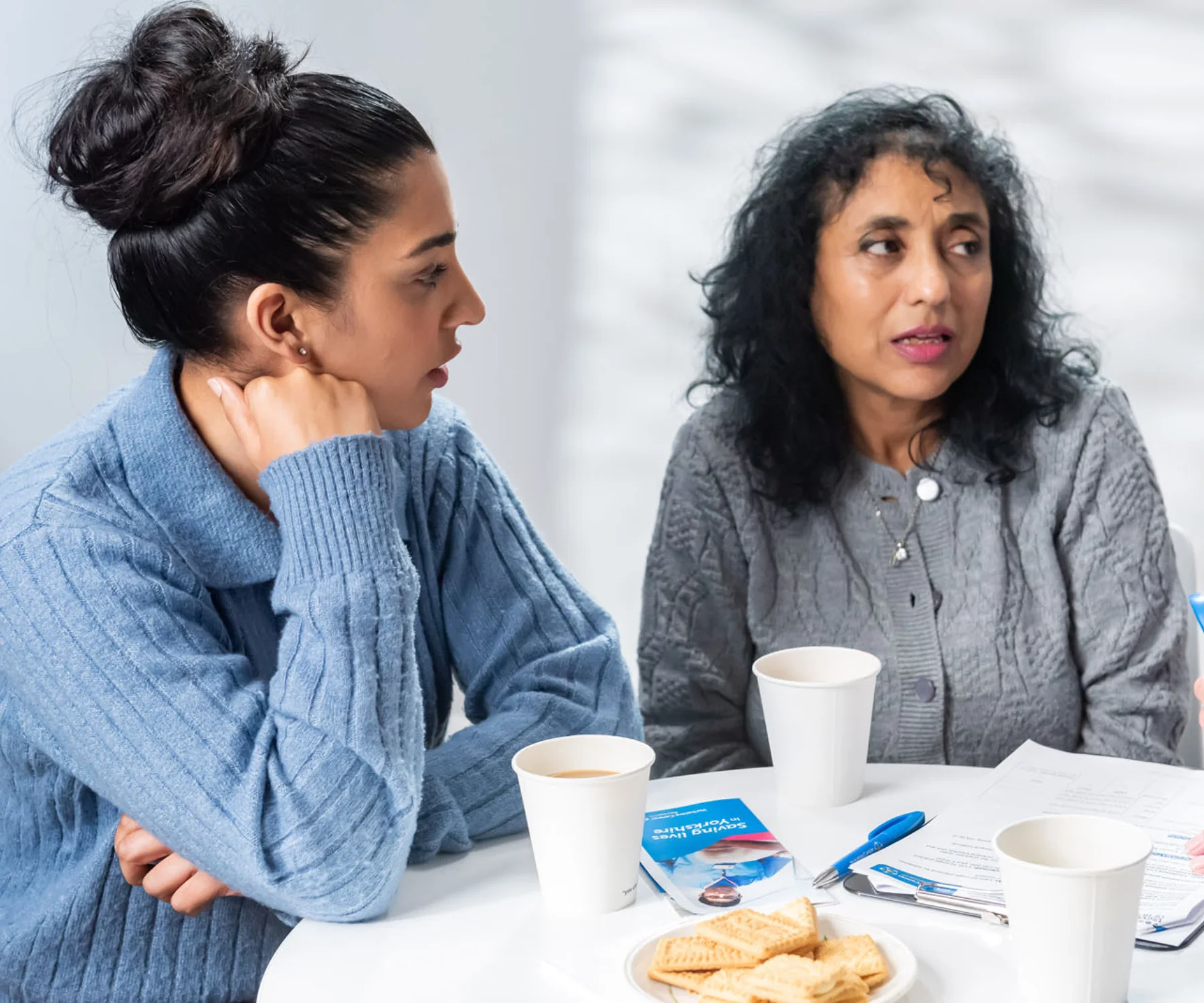 Two women sitting around a table