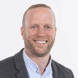 Headshot of a man with a beard smiling