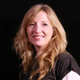 A lady with long blonde hair smiling