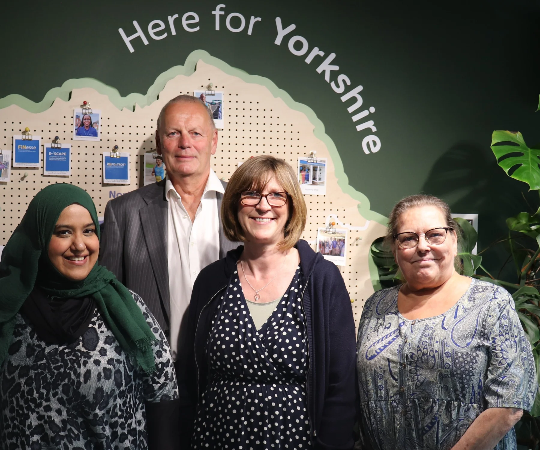 a man and three women stand together