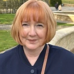 A lady with a ginger bob and navy coat