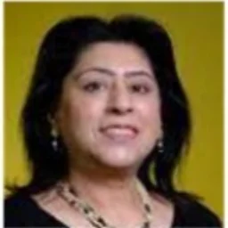 A lady with dark hair and a chunky necklace