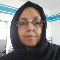 A lady in a head scarf and glasses