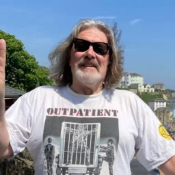 A man with long hair, beard and sunglasses