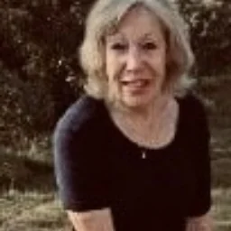 A lady with shoulder length hair and a black top