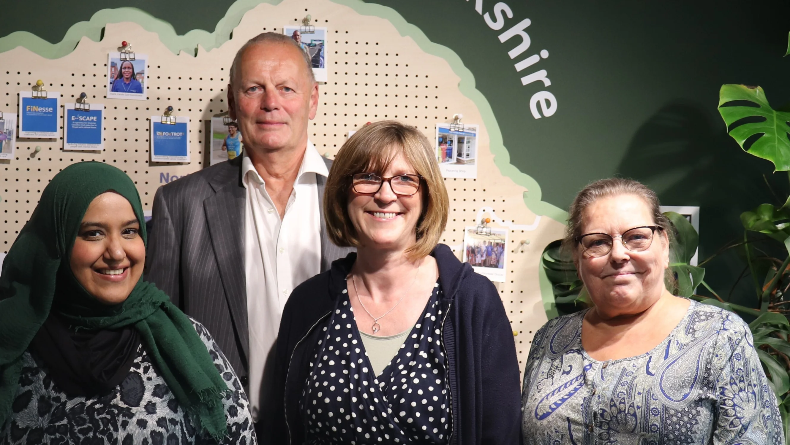 a man and three women stand together