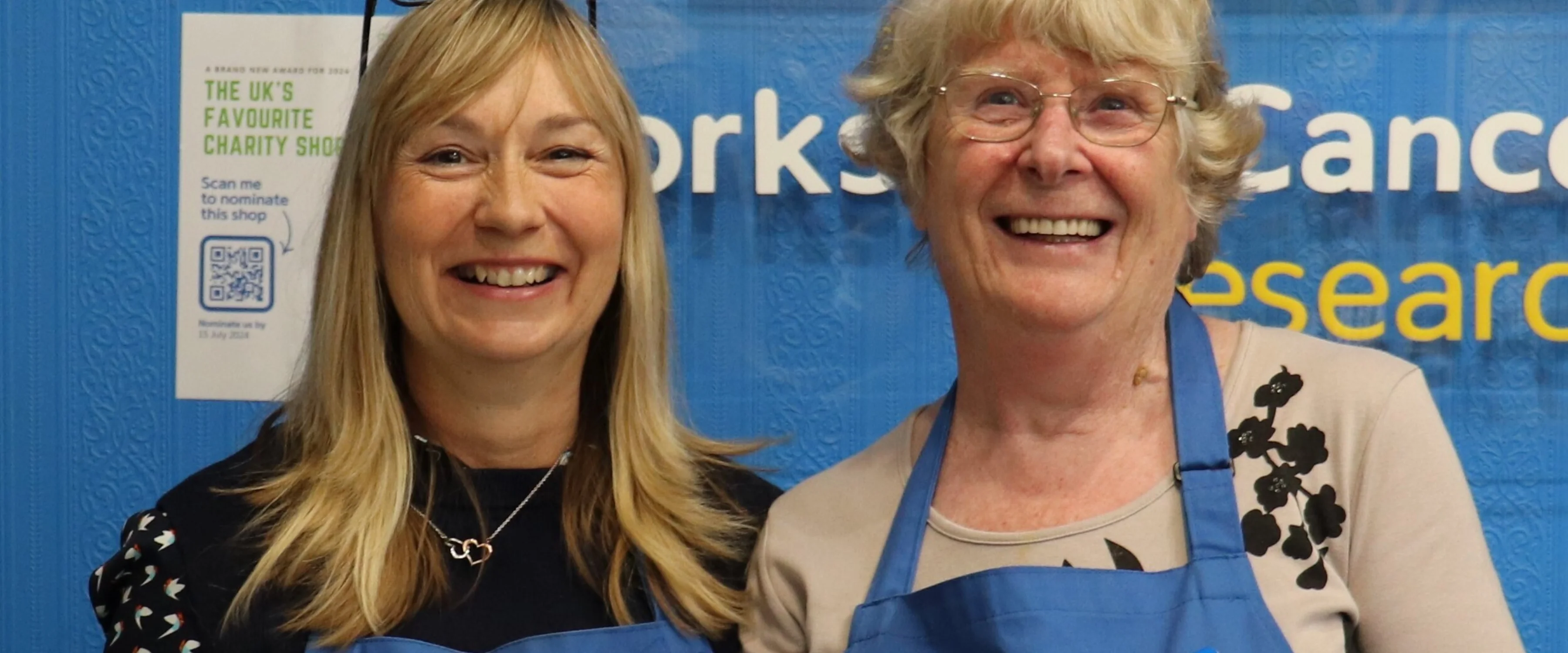 Two shop assistants behind the counter at the Yorkshire Cancer Research charity shop in Harrogate