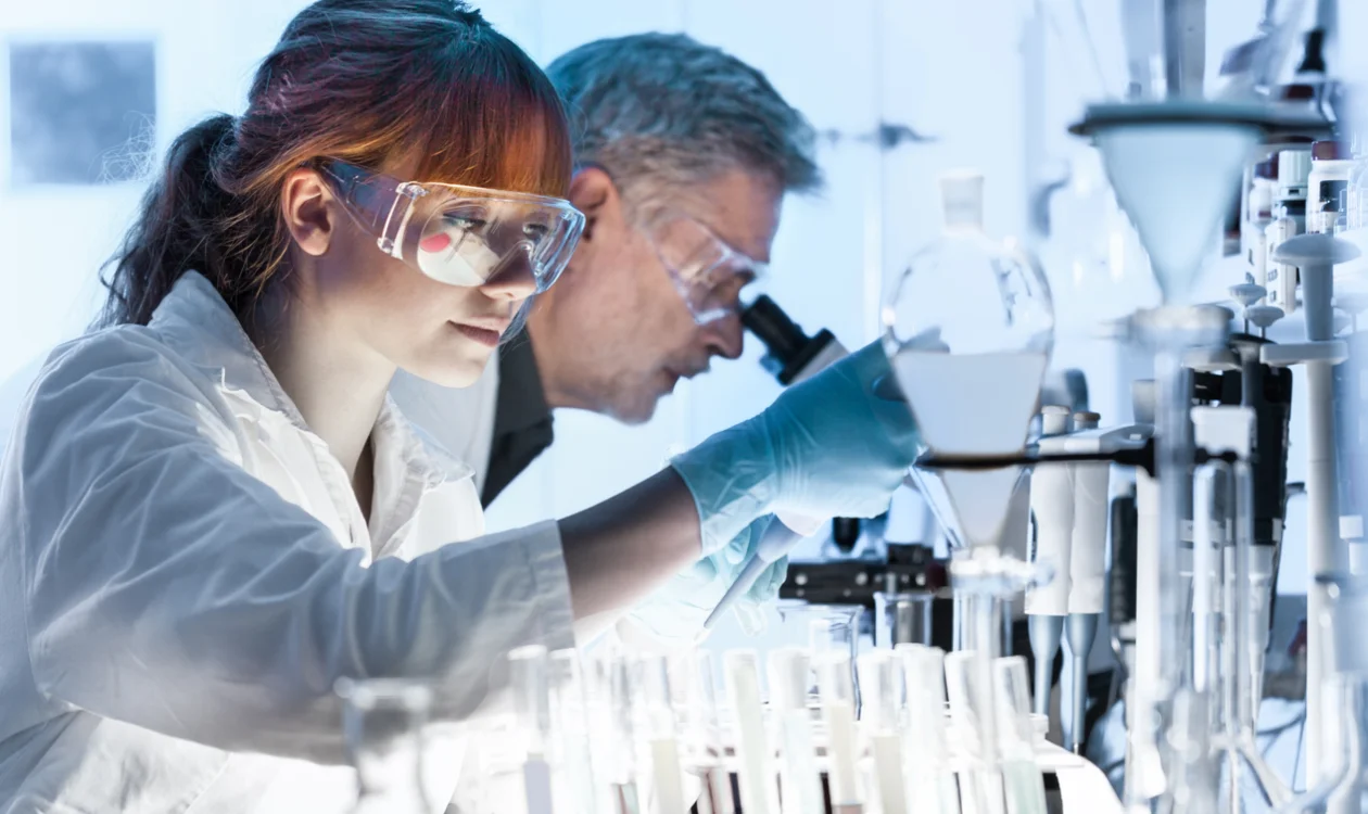 Researcher looking at a test tube
