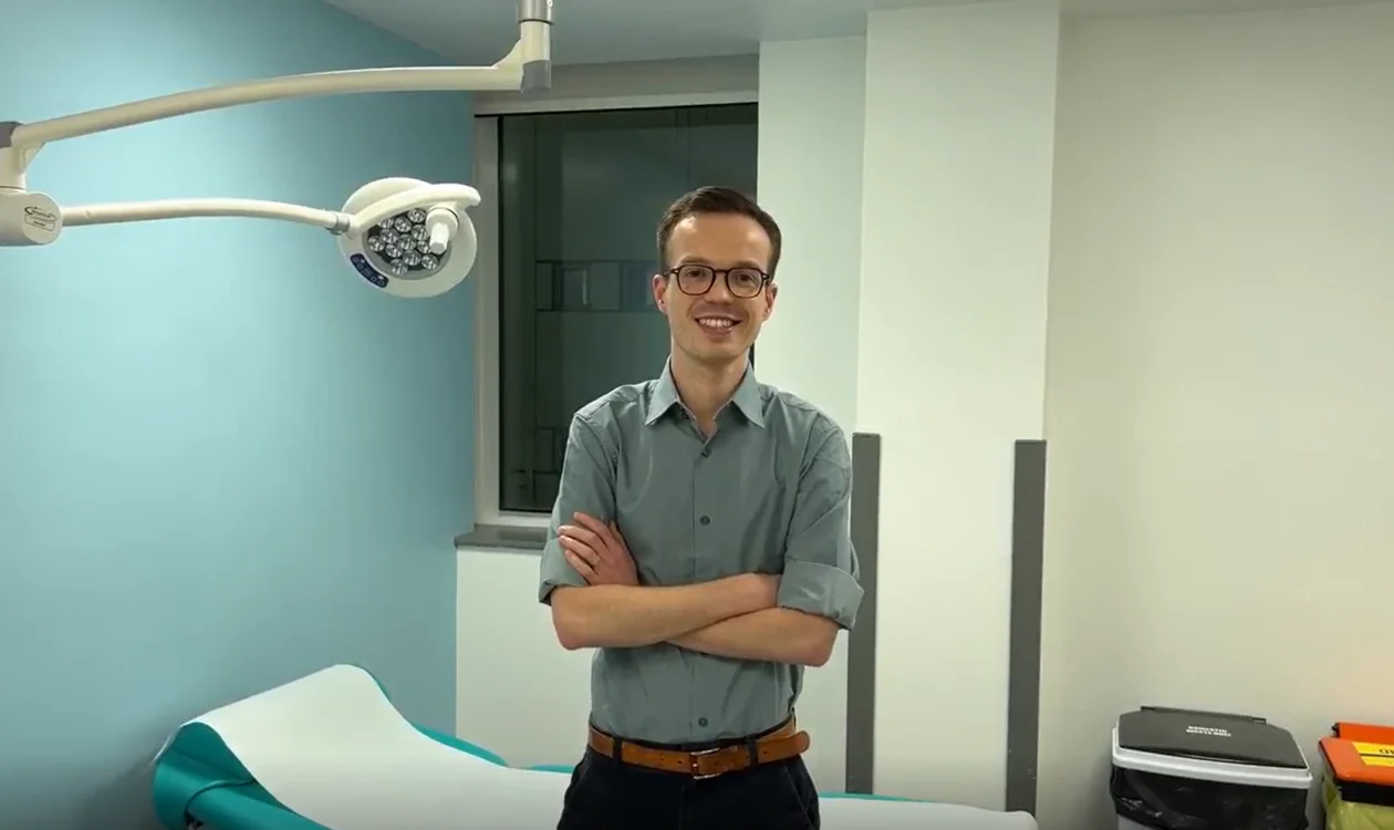 Jordan with his arms crossed in a healthcare environment