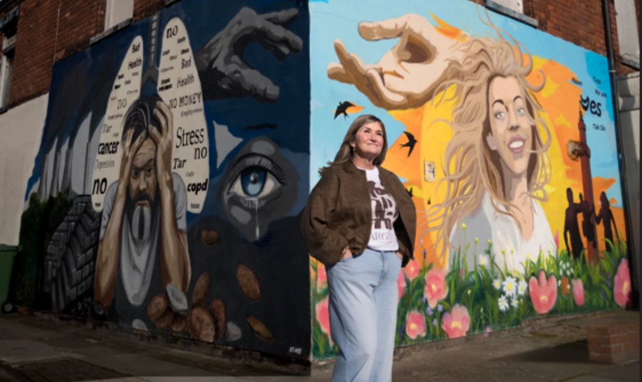 Wendy standing in front of the 'Turn the Corner' campaign wall
