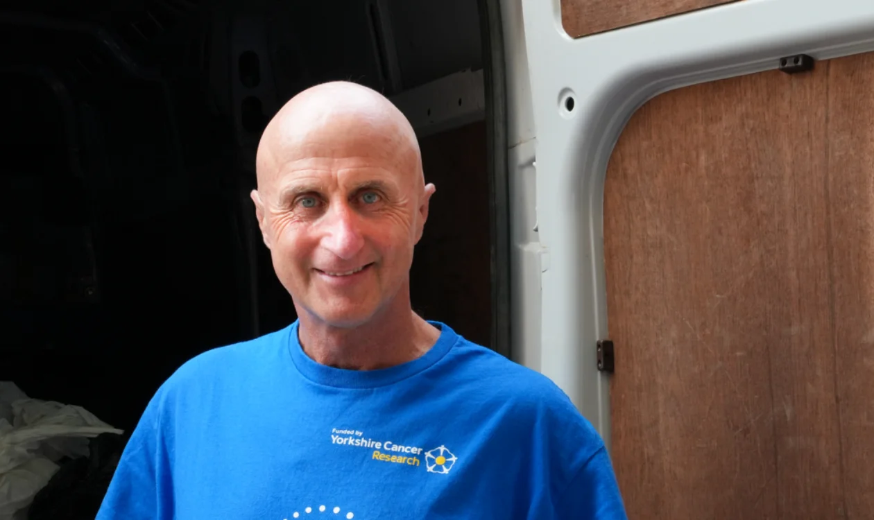 Alastair standing in front of the Yorkshire Cancer Research van