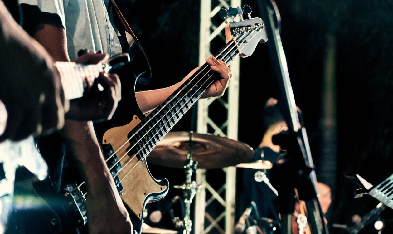 Generic image of a man playing a guitar on stage.