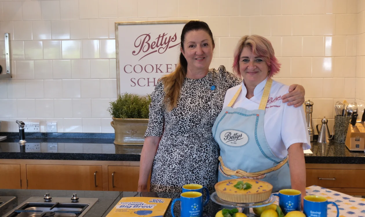 Two ladies stand in the Bettys cookery school