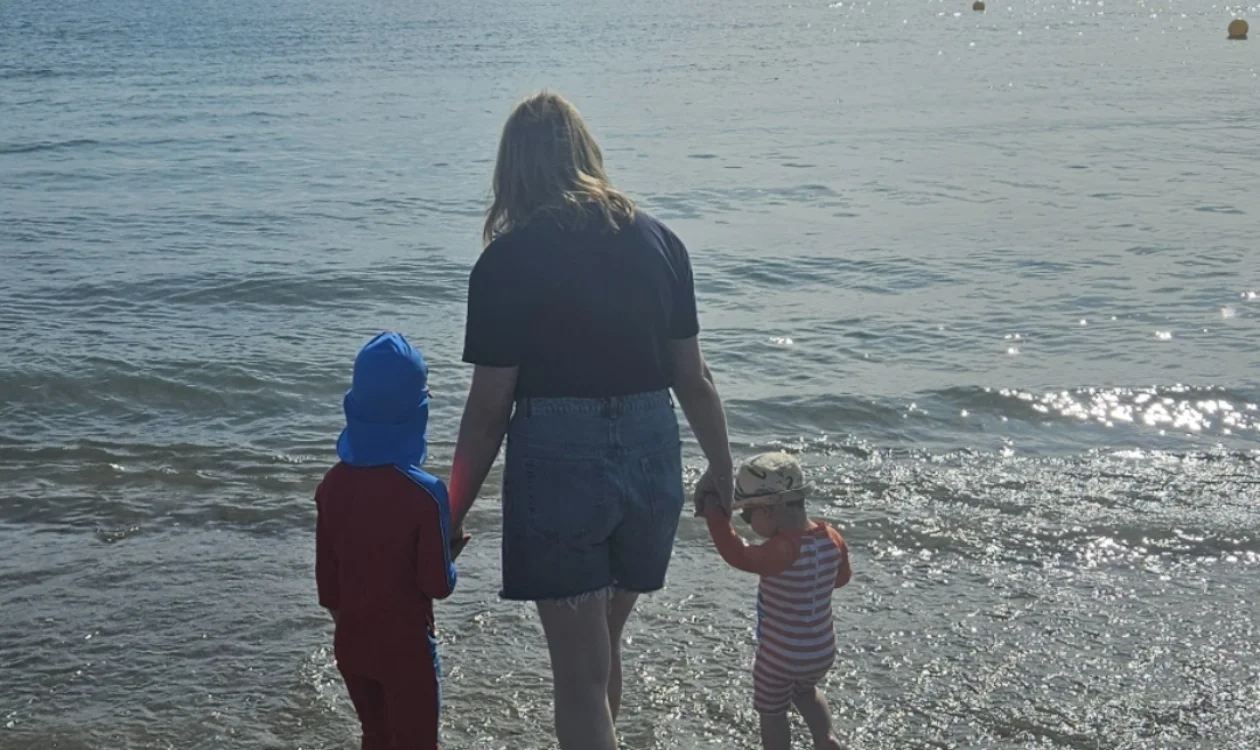 Beth with her two daughters walking into the sea