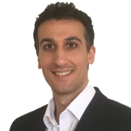 Man smiling at camera wearing a suit
