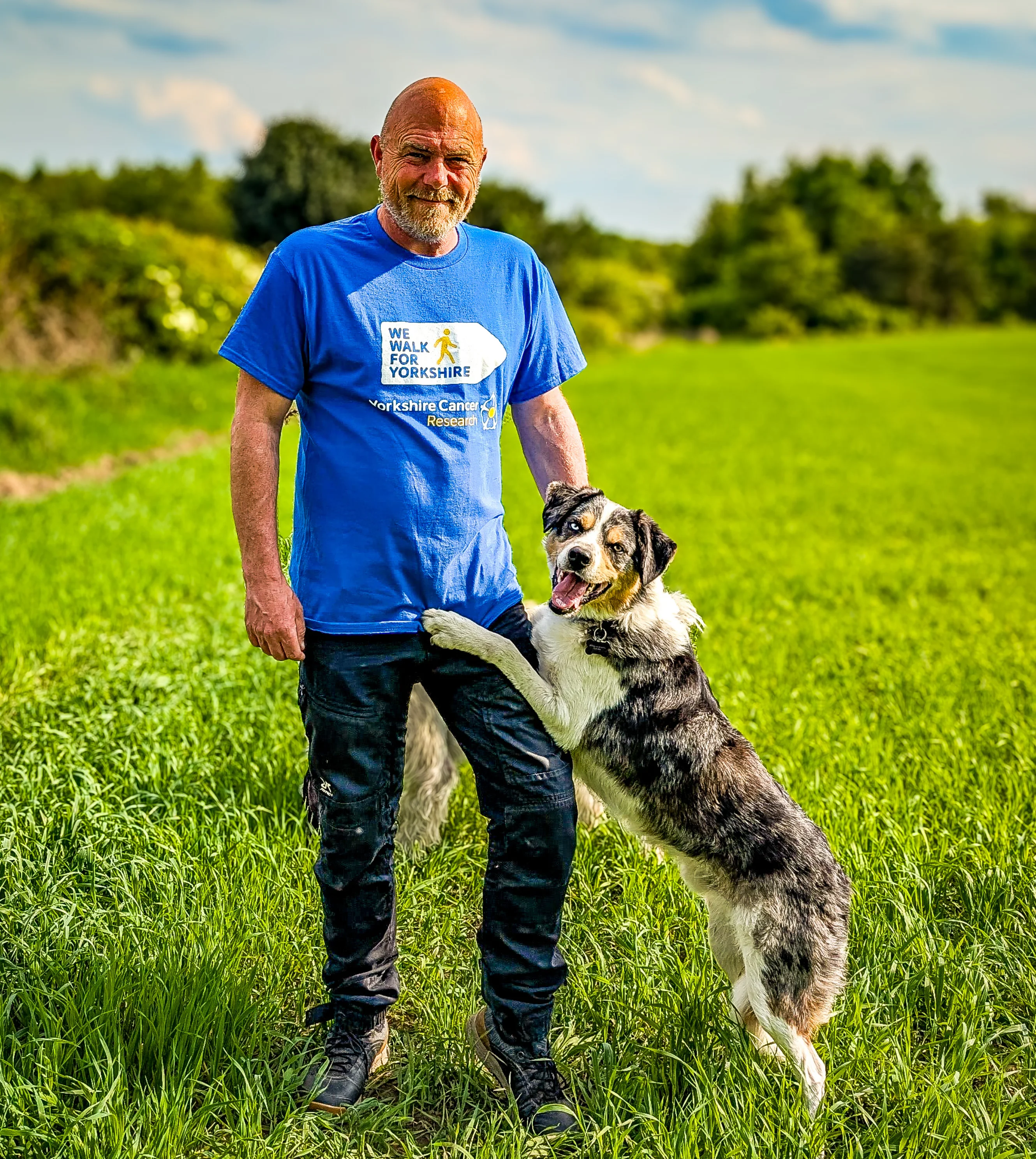 Paul Steele with his dog, Malc against the Yorkshire countryside
