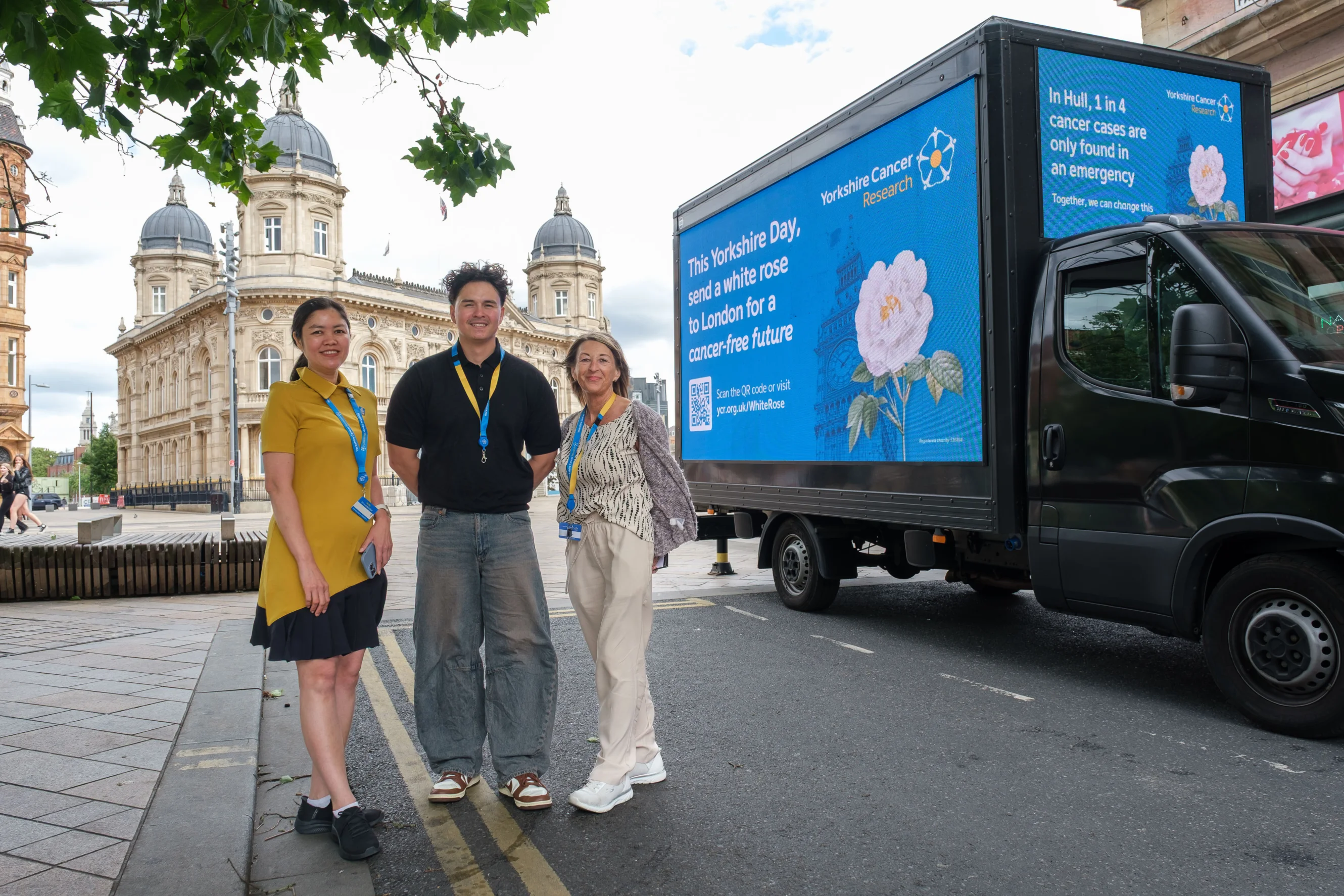 Hull shop volunteer and employees pose with the ad van outside of Hull City Hall.