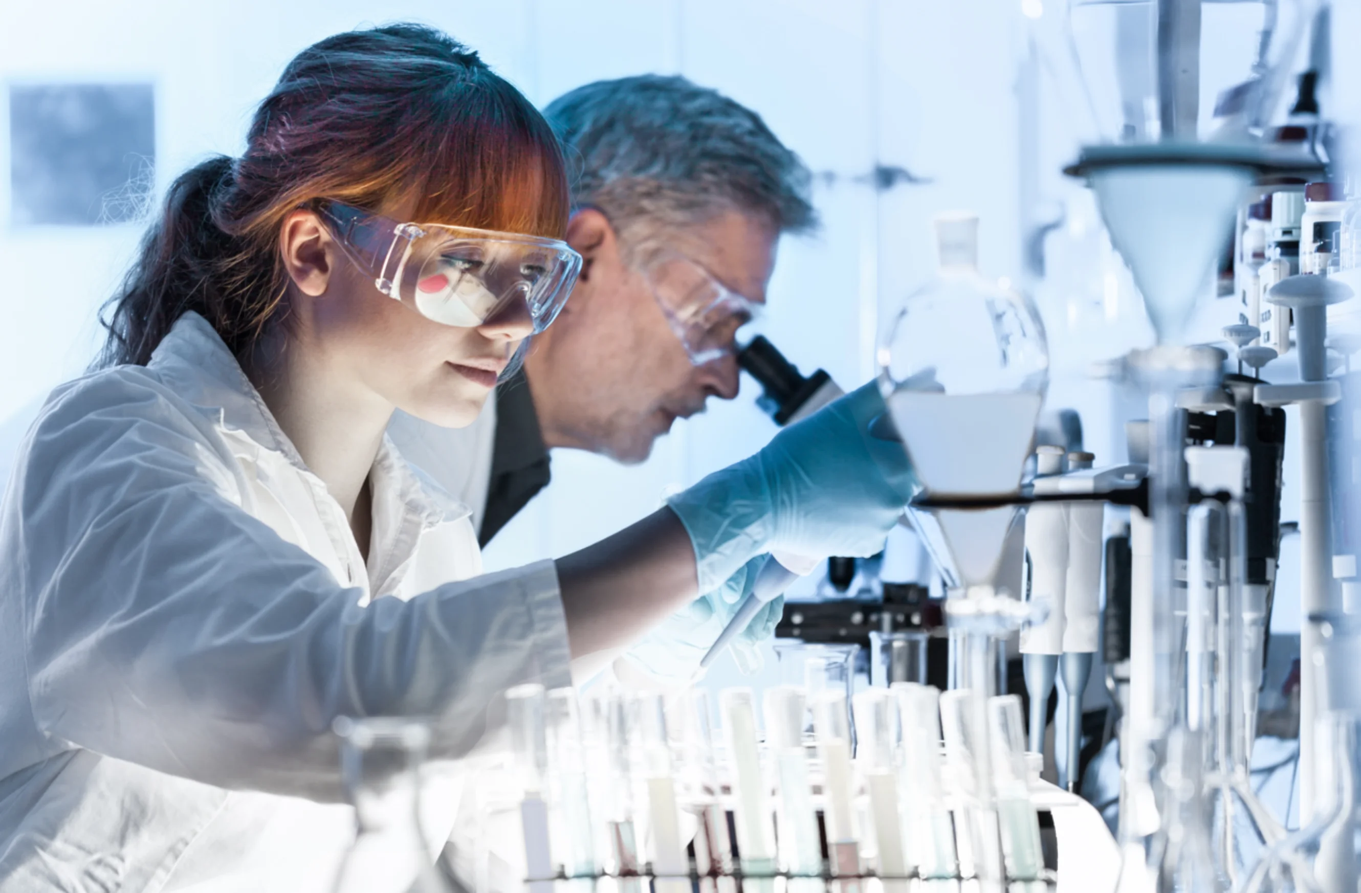 Researcher looking at a test tube
