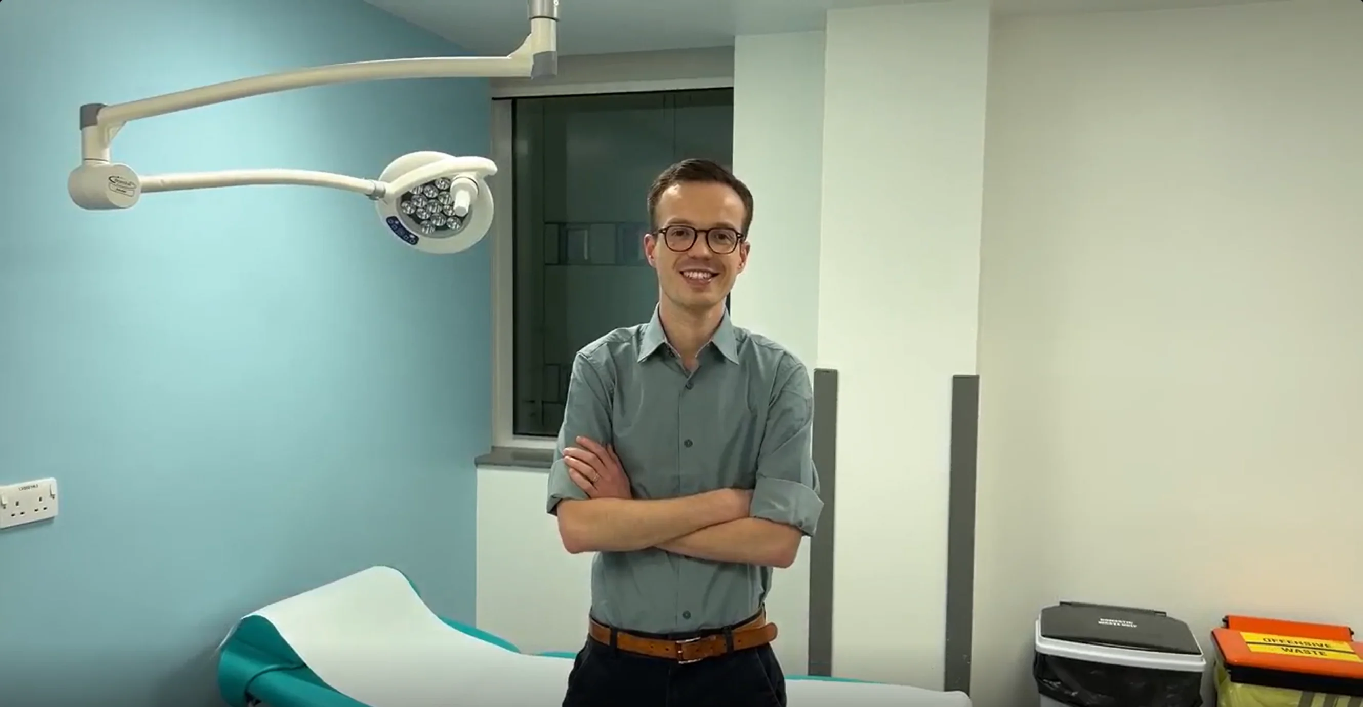 Jordan with his arms crossed in a healthcare environment