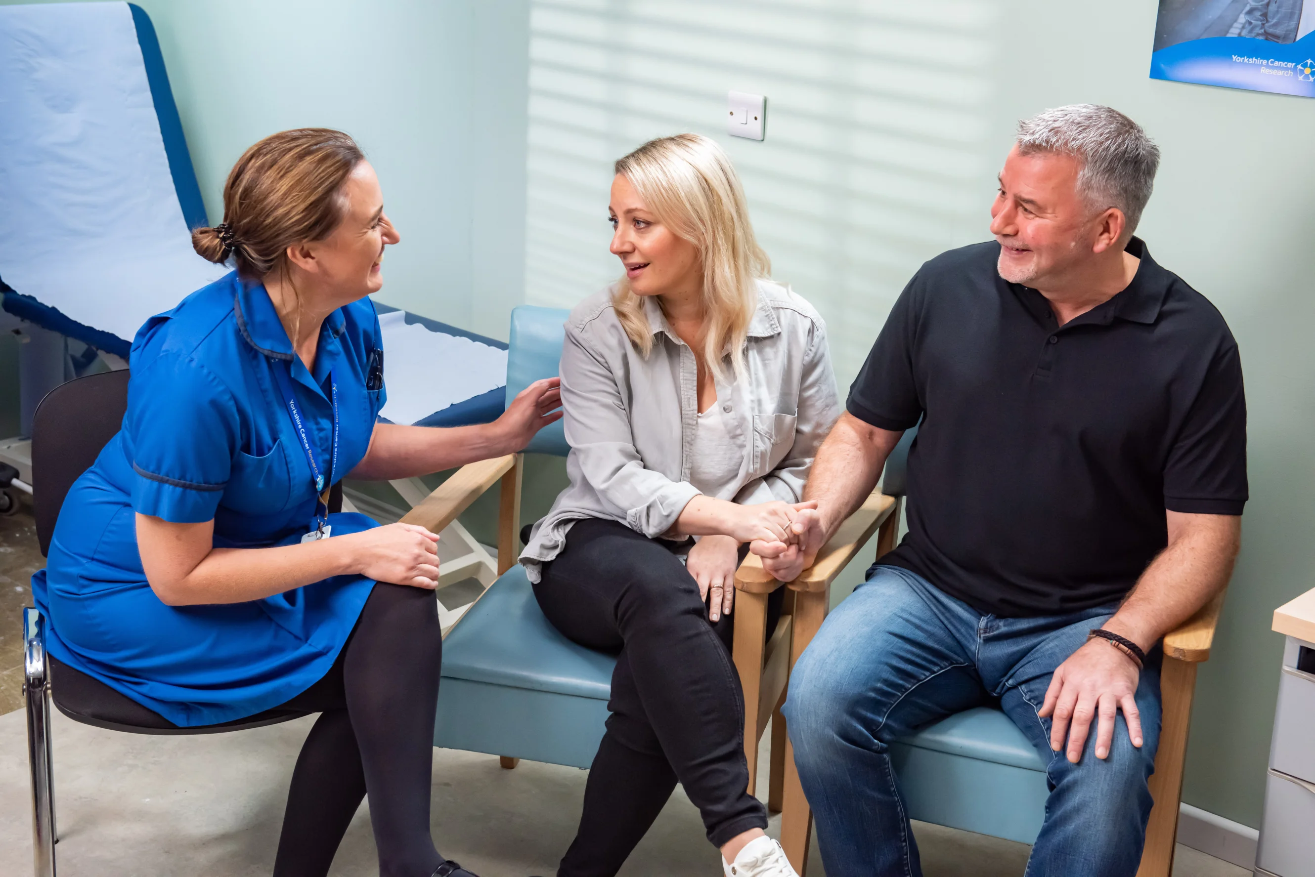A couple speak to a nurse after receiving good news