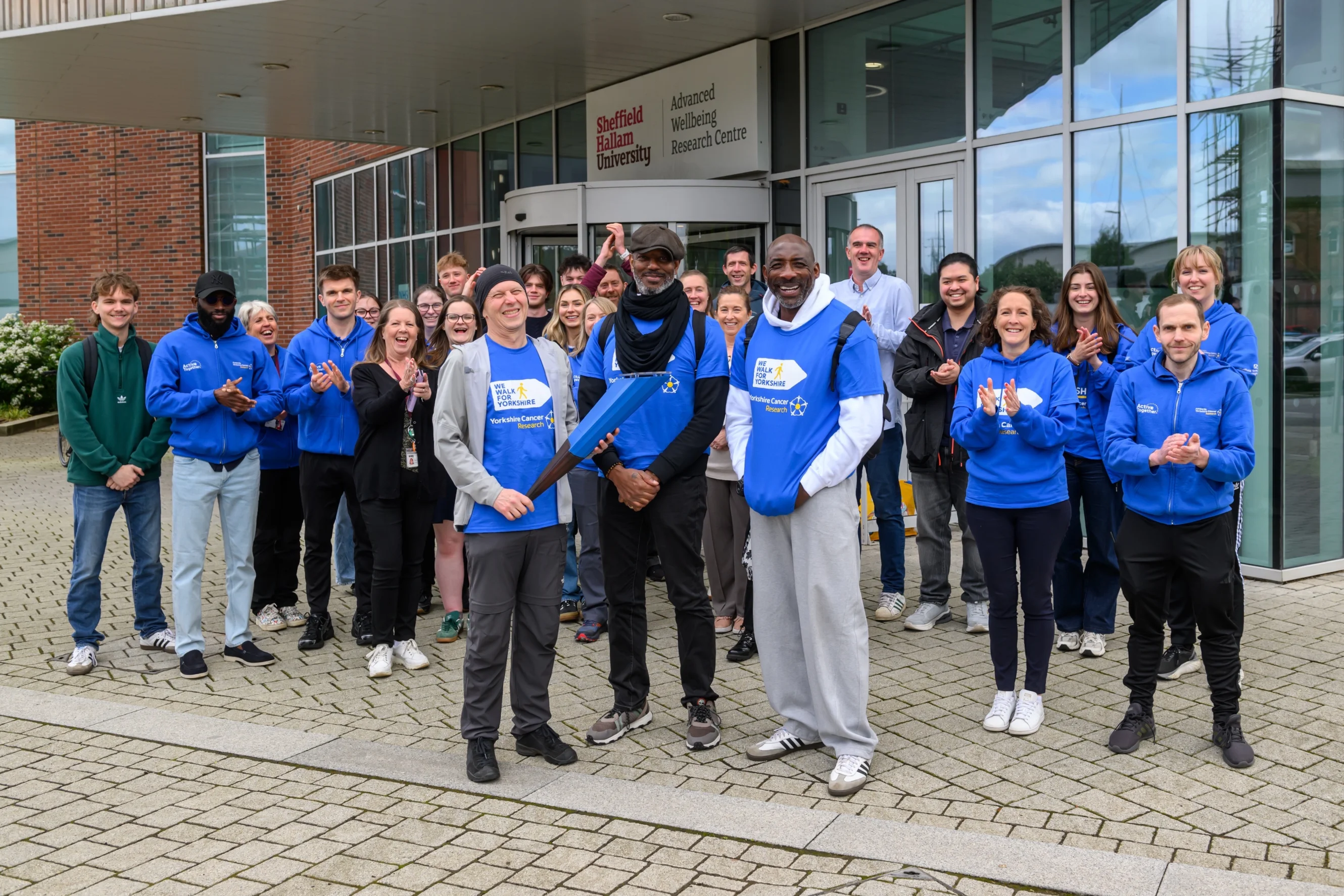 Aaron passing the baton over to Simon at the Advanced Wellbeing Research Centre