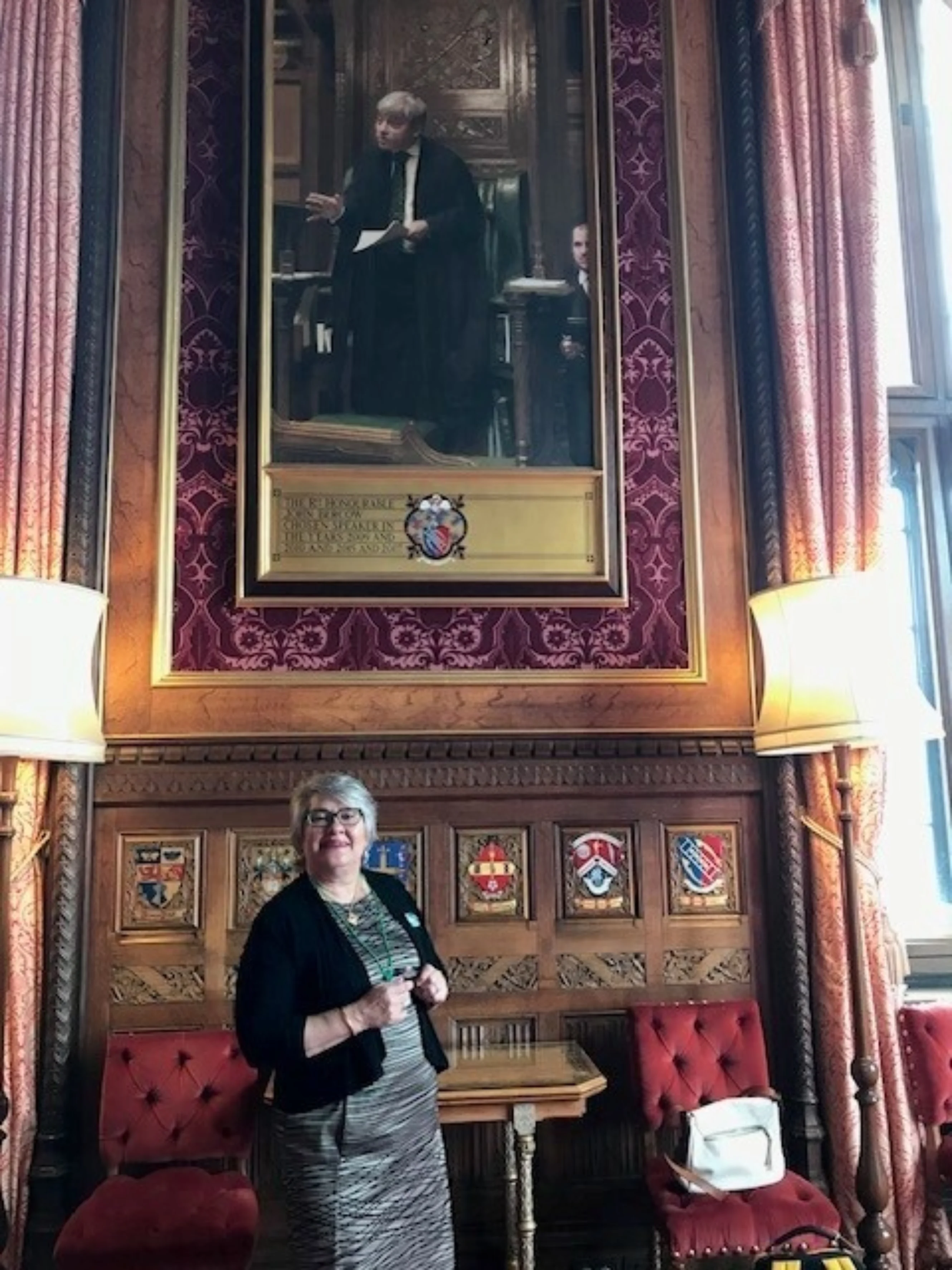 Woman standing in front of a portrait painting in a museum